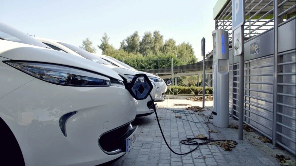 A queue of electric vehicles charging at a public fast-charging station in Europe, representing the record surge in EV registrations across EU markets in March 2026.